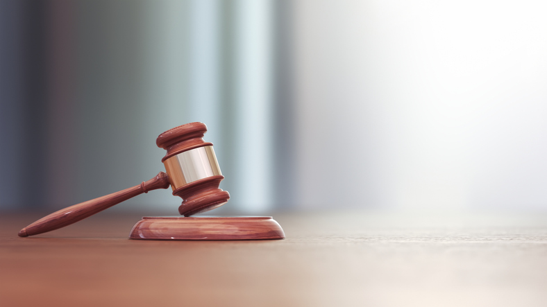 A gavel on a wooden surface
AI-generated content may be incorrect.